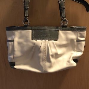 Cream coach purse trimmed in grey